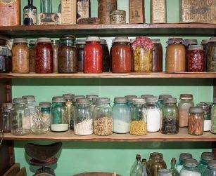pantry stocked with glass jars of food and ingredients