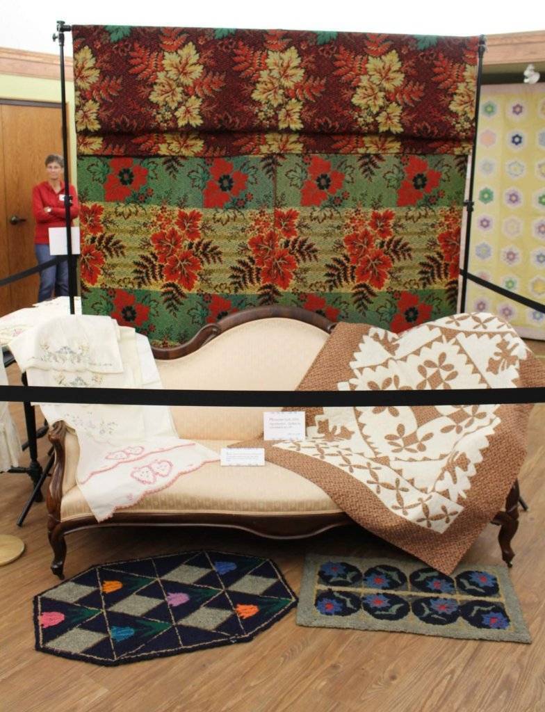 settee, wall hanging, and rugs in quilt and textile show