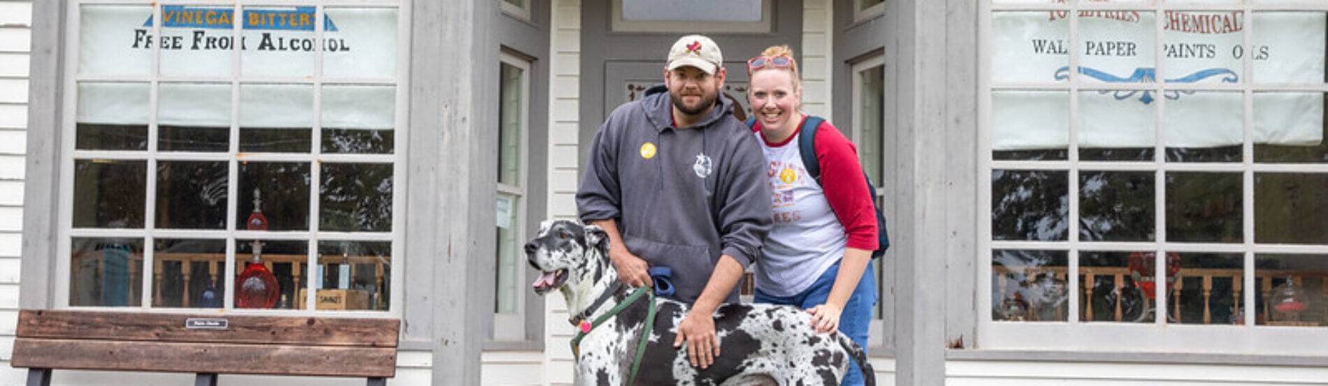 guests with great dane on porch of drug store