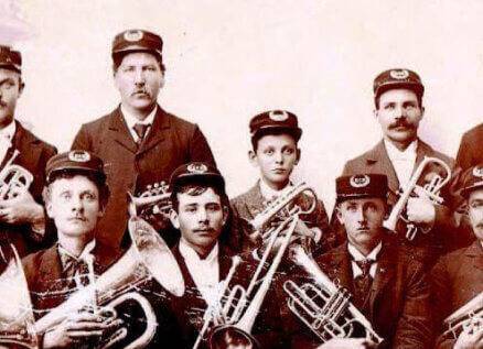 sepia portrait of men holding band instruments