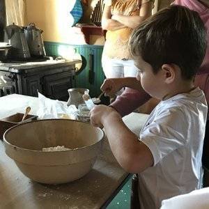 child mixing dough