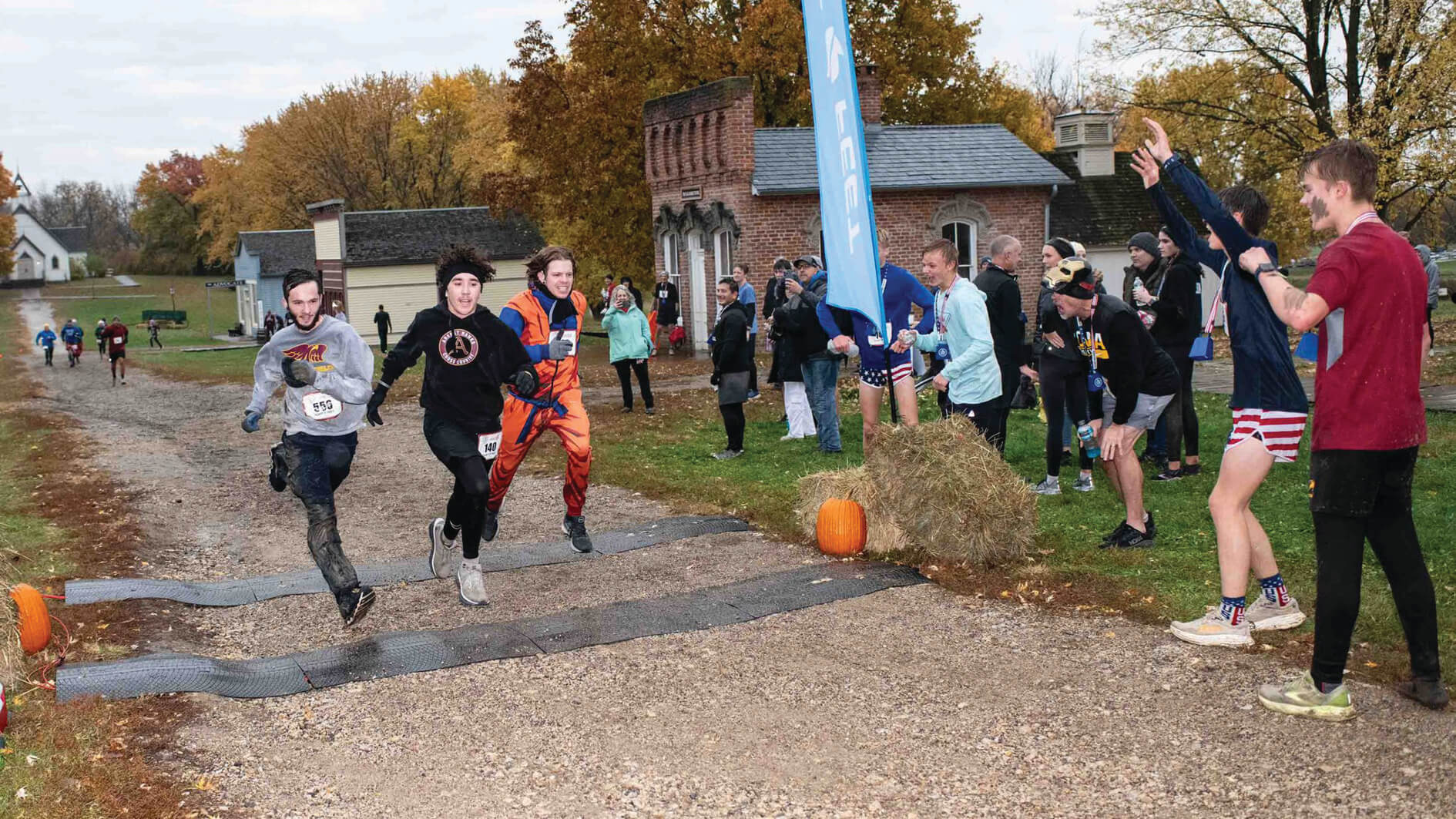 runners crossing finish line in historic town