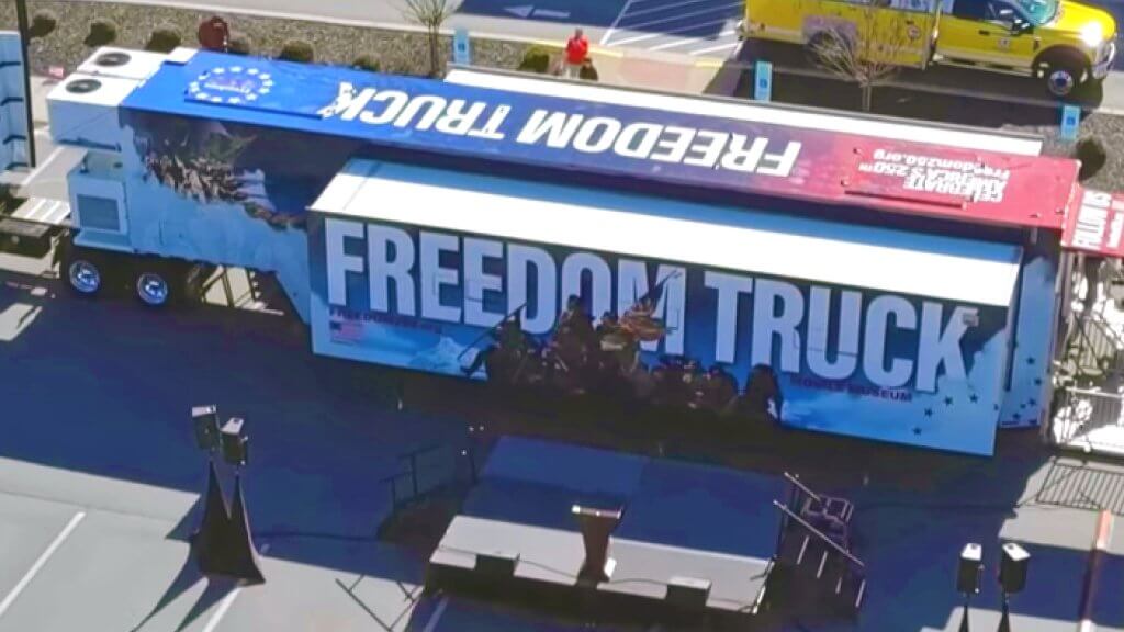 aerial exterior view of semi trailer with freedom truck signage